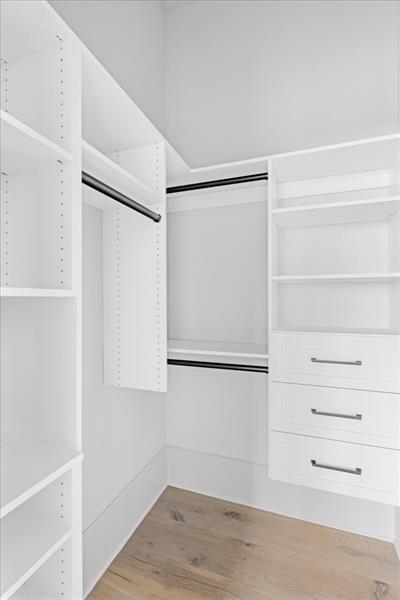 walk in closet featuring light hardwood / wood-style flooring