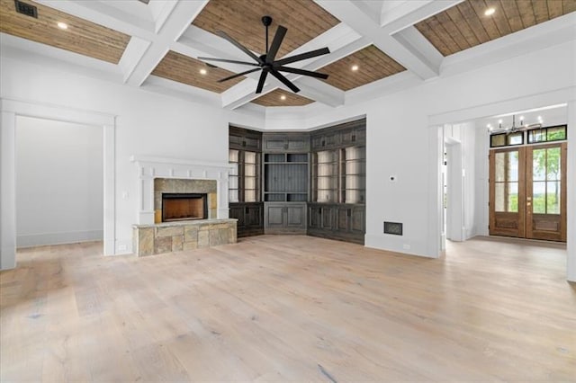 unfurnished living room with french doors, light hardwood / wood-style flooring, ceiling fan, a fireplace, and wood ceiling