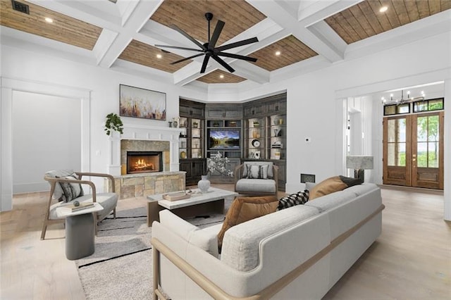 living room featuring wooden ceiling, french doors, coffered ceiling, a fireplace, and beamed ceiling