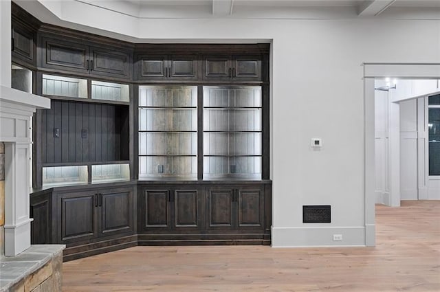 entrance foyer with beamed ceiling and light hardwood / wood-style flooring