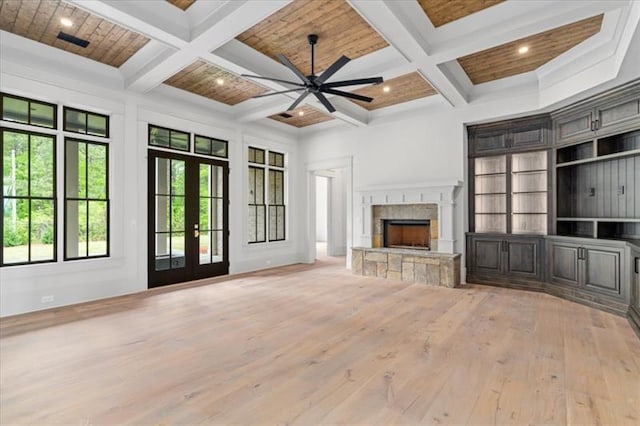 unfurnished living room with beam ceiling, french doors, wood ceiling, and coffered ceiling