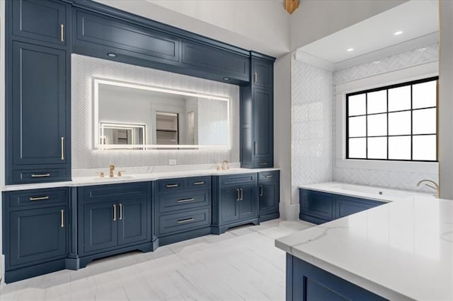 bathroom featuring vanity and a washtub