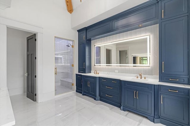 bathroom with tiled shower and vanity