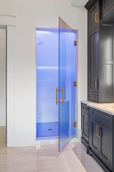 bathroom featuring vanity and an enclosed shower