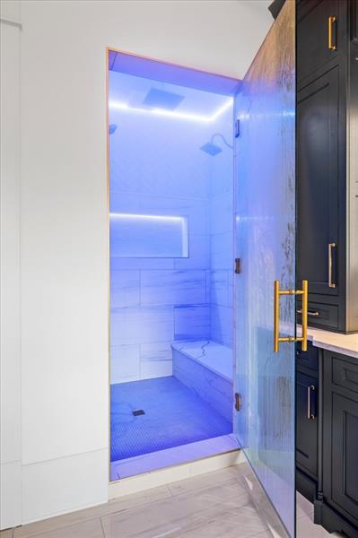 bathroom with vanity and tiled shower