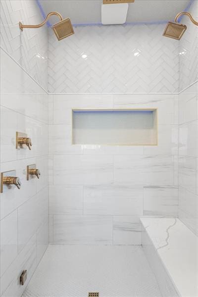 bathroom with a tile shower