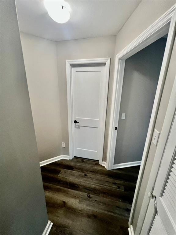 hallway with dark hardwood / wood-style flooring