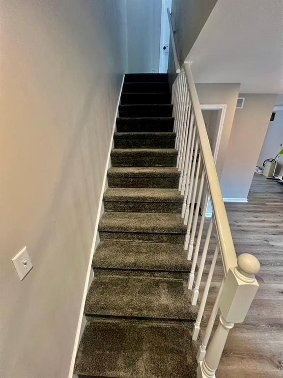 stairs with wood-type flooring