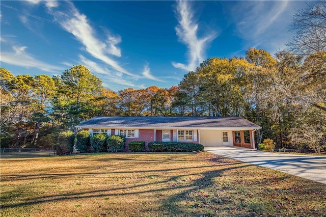 single story home featuring a carport and a front lawn