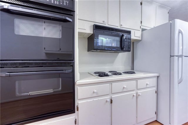 kitchen featuring white cabinetry and black appliances