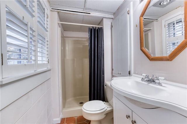 bathroom featuring a shower with shower curtain, tile patterned flooring, toilet, and vanity