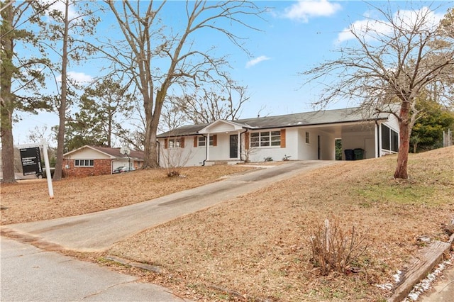 ranch-style house featuring a carport