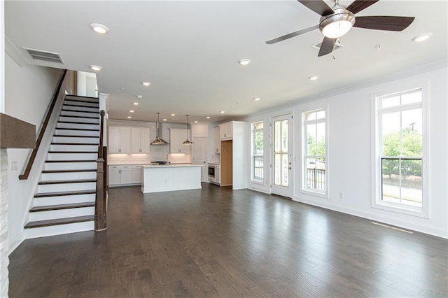 348 Olmstead Way Unit 30, Alpharetta, GA 30022 - unfurnished living room featuring ornamental molding, recessed lighting, dark wood finished floors, stairs, and a ceiling fan