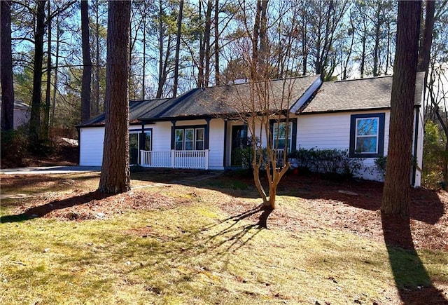 ranch-style home featuring a garage and a front lawn