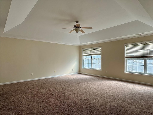 spare room with a raised ceiling, ornamental molding, carpet flooring, and ceiling fan