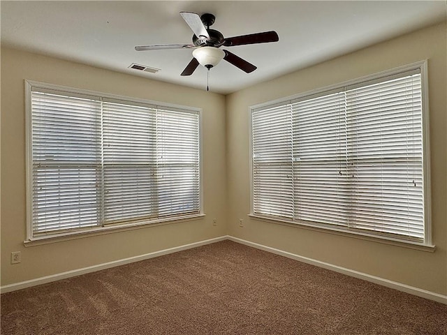 spare room featuring carpet floors and ceiling fan