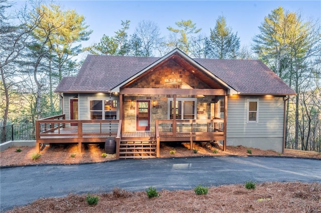 rustic home with roof with shingles