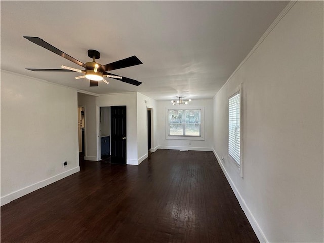 empty room with crown molding, ceiling fan, and dark hardwood / wood-style flooring