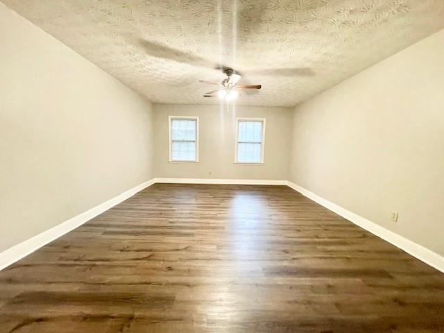 spare room featuring ceiling fan, a textured ceiling, and dark hardwood / wood-style flooring