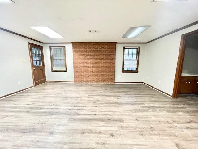 spare room featuring light hardwood / wood-style floors and crown molding