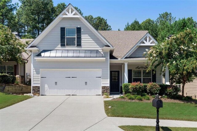 craftsman-style home with a garage and a front yard