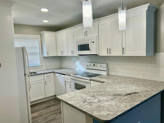 kitchen featuring pendant lighting, white appliances, light stone countertops, dark hardwood / wood-style floors, and white cabinetry