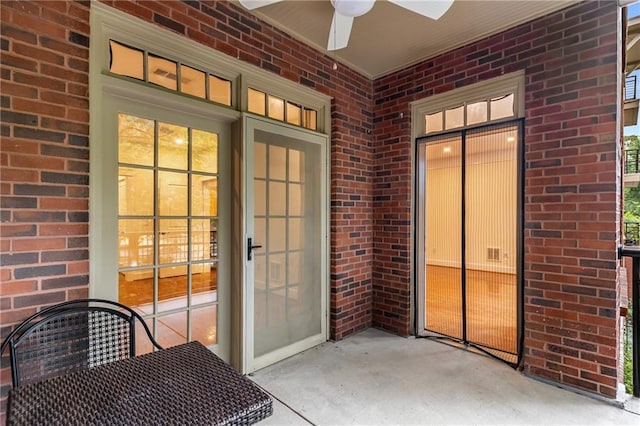 view of exterior entry with a ceiling fan