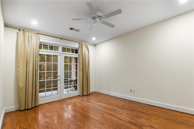 empty room featuring visible vents, wood finished floors, recessed lighting, french doors, and baseboards