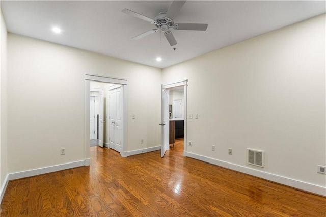 unfurnished bedroom featuring visible vents, baseboards, recessed lighting, wood finished floors, and a ceiling fan