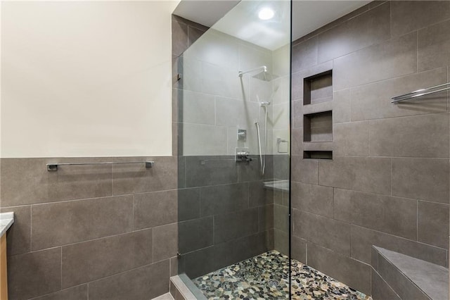 bathroom featuring tile walls and walk in shower