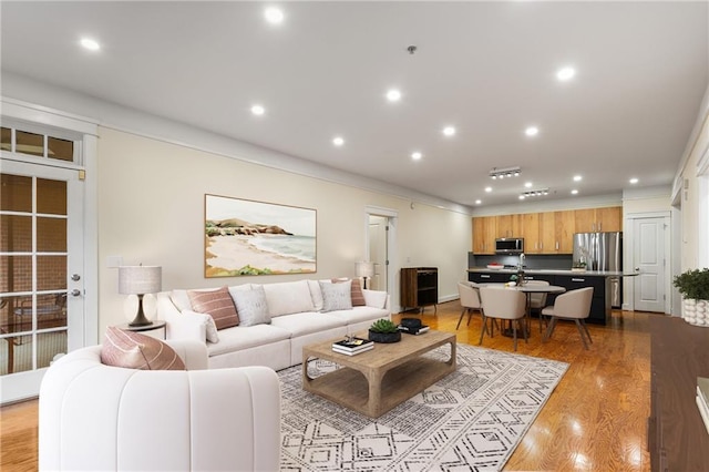 living room featuring light wood-style flooring and recessed lighting