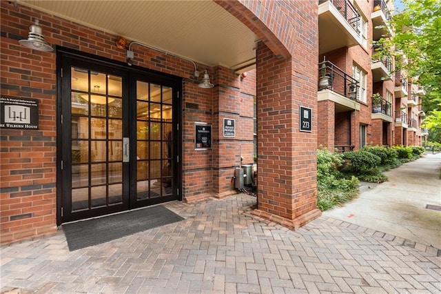 doorway to property with french doors and brick siding