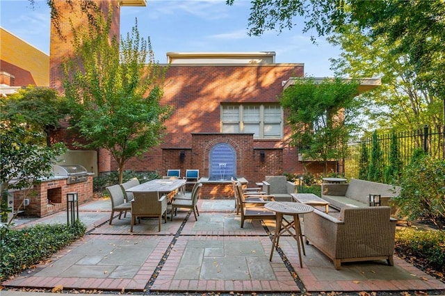 view of patio / terrace with an outdoor living space, fence, outdoor dining area, area for grilling, and an outdoor kitchen