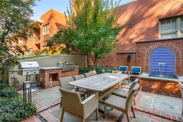 view of patio featuring area for grilling, an outdoor kitchen, and outdoor dining space