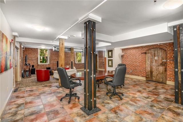 office featuring brick wall and baseboards