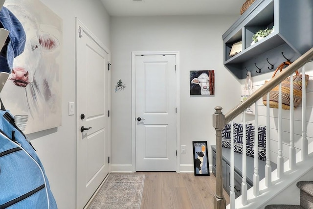 mudroom with baseboards and light wood finished floors