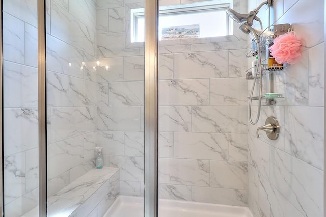 bathroom with plenty of natural light and a shower stall