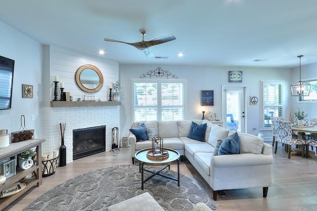 living room with a healthy amount of sunlight, visible vents, and wood finished floors