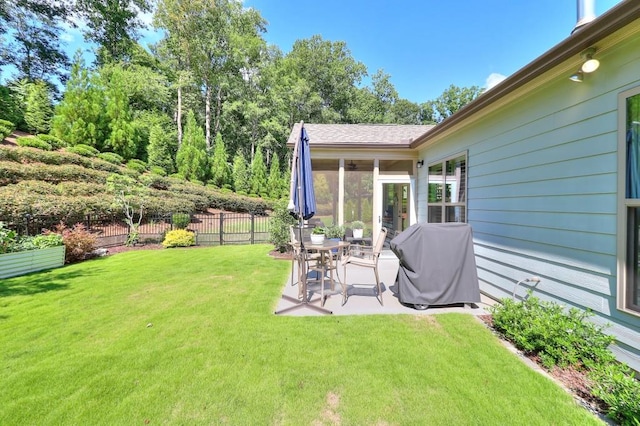 view of yard featuring a patio area, fence, and a sunroom