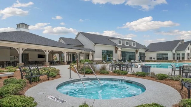 community pool with a community hot tub and a patio