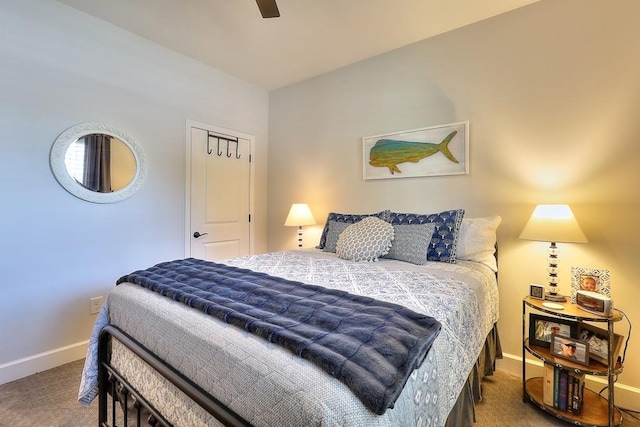 carpeted bedroom with a ceiling fan and baseboards