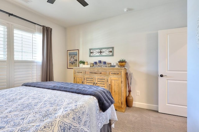 bedroom with visible vents, baseboards, a ceiling fan, and light colored carpet