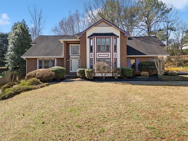 traditional home with brick siding and a front lawn