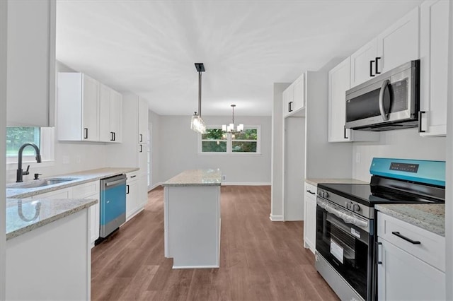 4477 Timber Ridge Dr, Douglasville, GA 30135 - kitchen featuring stainless steel appliances, a chandelier, plenty of natural light, and white cabinetry