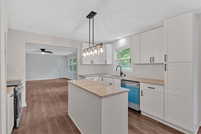 4477 Timber Ridge Dr, Douglasville, GA 30135 - kitchen featuring appliances with stainless steel finishes, a kitchen island, dark wood-type flooring, and white cabinetry