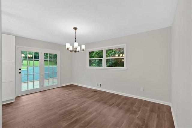 4477 Timber Ridge Dr, Douglasville, GA 30135 - unfurnished room with dark wood finished floors and a chandelier