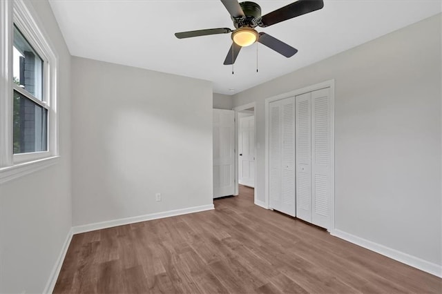 4477 Timber Ridge Dr, Douglasville, GA 30135 - unfurnished bedroom with wood finished floors, a closet, and ceiling fan