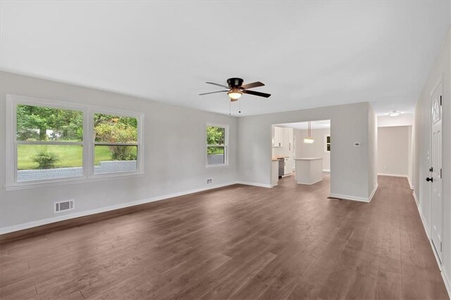 4477 Timber Ridge Dr, Douglasville, GA 30135 - unfurnished living room with dark wood finished floors, a ceiling fan, and healthy amount of natural light