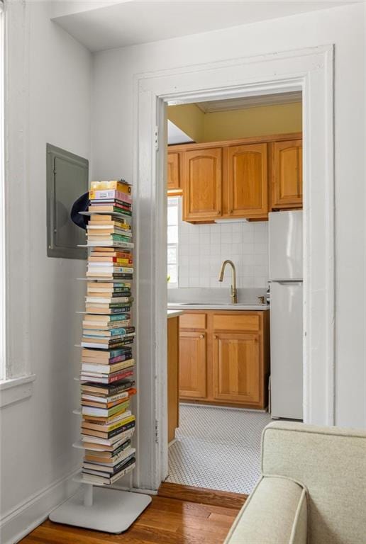 737 Barnett St NE Unit B6, Atlanta, GA 30306 - kitchen with freestanding refrigerator, electric panel, wood finished floors, light countertops, and decorative backsplash