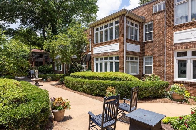 737 Barnett St NE Unit B6, Atlanta, GA 30306 - back of house featuring brick siding and a patio